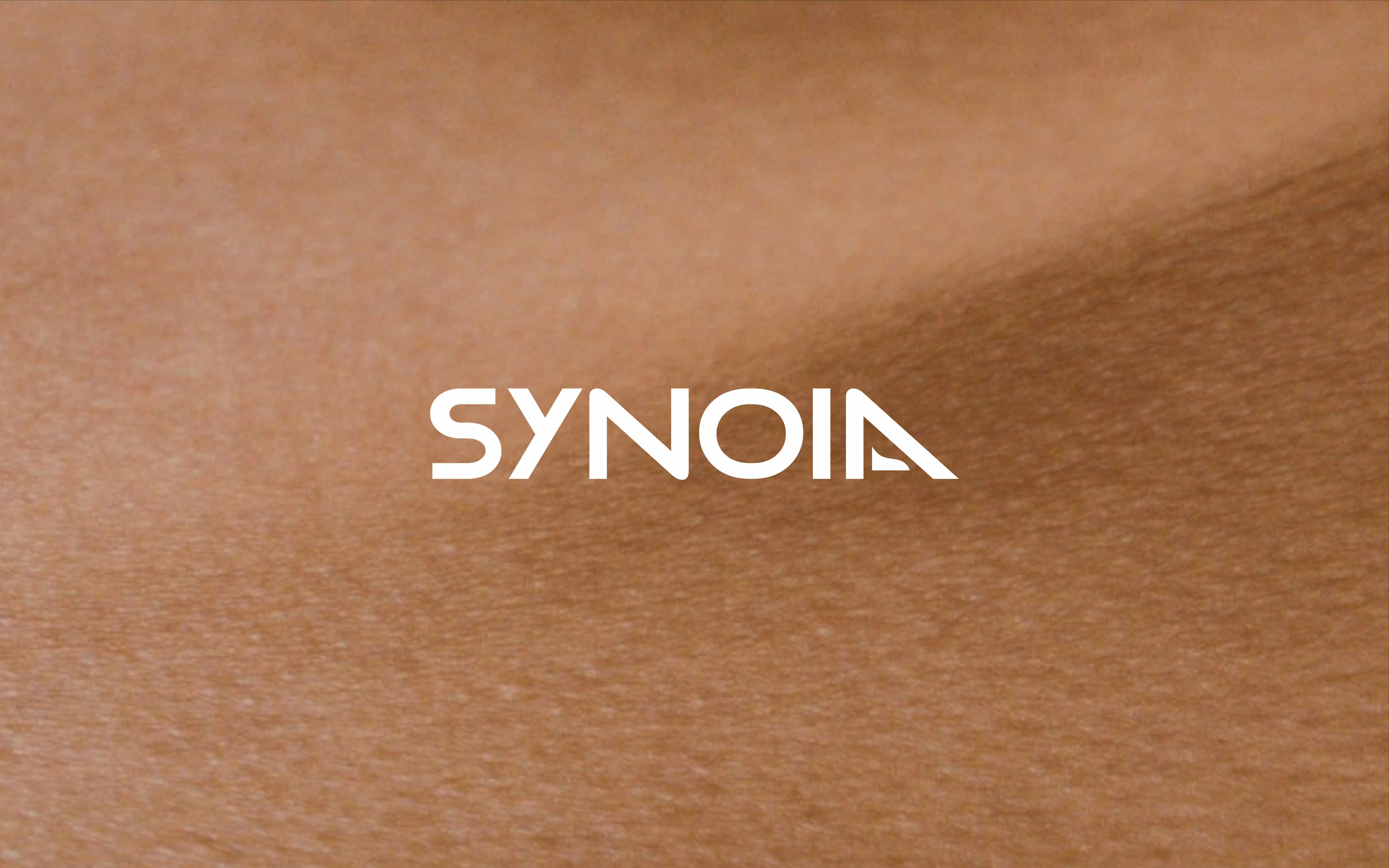 Synoia Technologies logo design on skin background created by Studio Wisdom branding agency.
