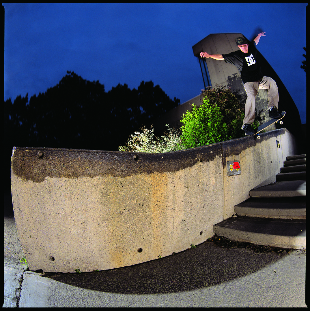 Skateboarder grinding handrail at iconic spot with ShredSpots brand headline, part of Studio Wisdom's skateboarding brand identity design
