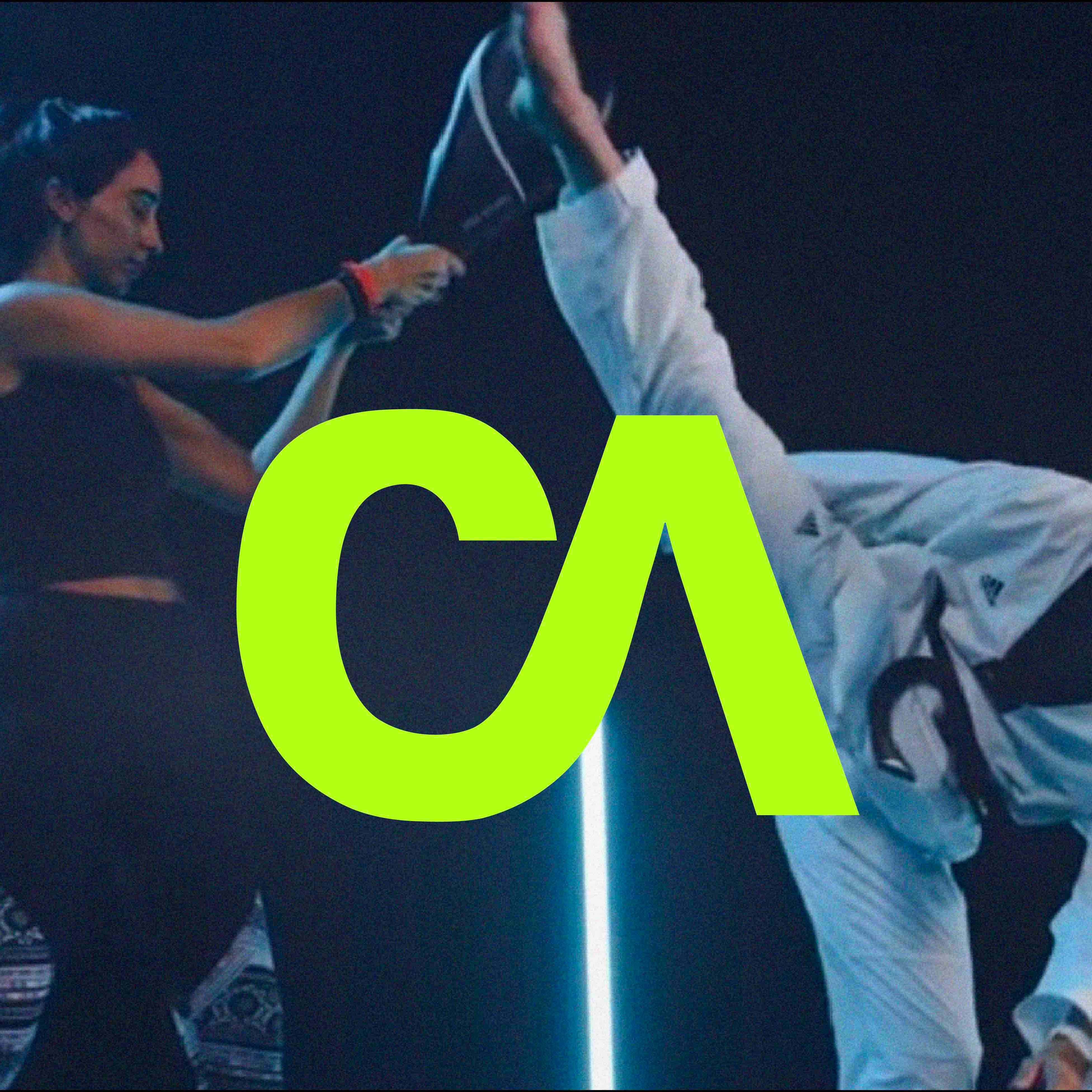 Martial artist mid-kick with neon CA logo overlay, showcasing the brand identity designed by Studio Wisdom for Cognitive Athletics