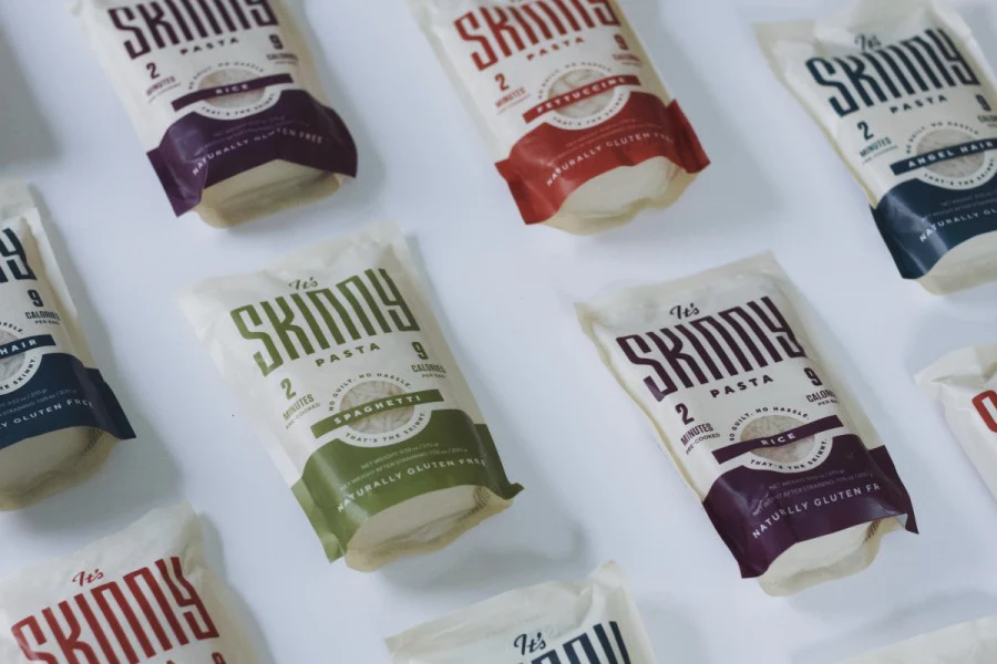 It’s Skinny Pasta angel hair pouch and plated gluten-free pasta meal with herbs, part of brand identity system created by Studio Wisdom