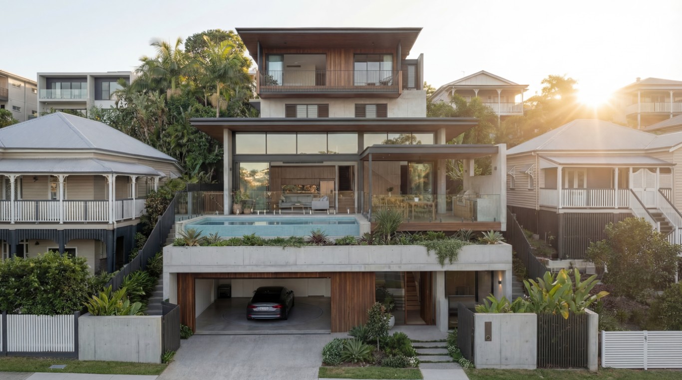 Three-level luxury home on Hamilton Brisbane sloping block — street garage with car turntable, cantilevered pool terrace, open-plan living above, Quorum Studios