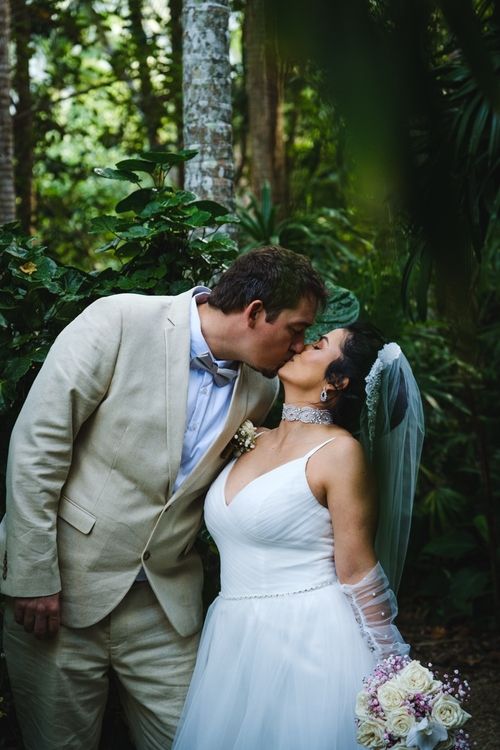 Couple kissing in the rain forest with a suoer beautiful light, wedding style