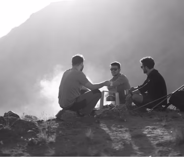 Three people laughing and talking during a mount Kilimanjaro climb