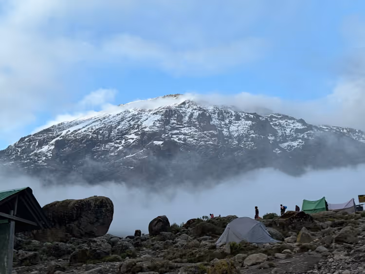 View of a cloudy peak of mount Kilimanjaro during an Uncharted Summits trek