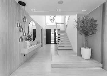 interior fit out of a villa's lobby featuring travertine stone and a grand staircase