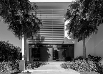 an exterior fit out of a grand villa in palm Jumeriah featuring walnut louvres