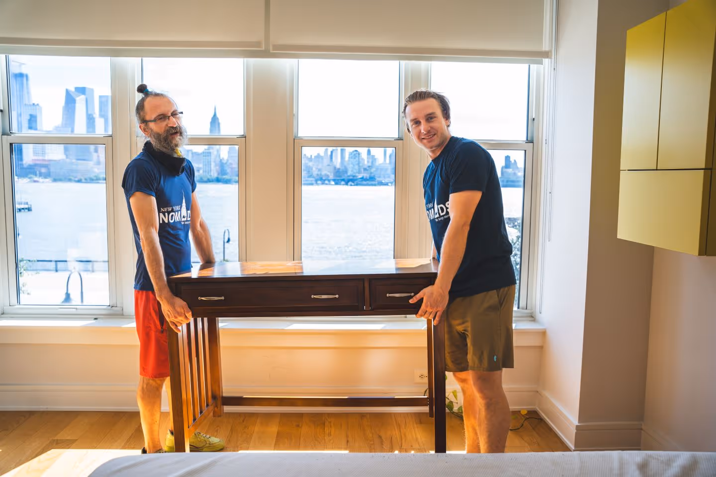 Two man carrying out a table