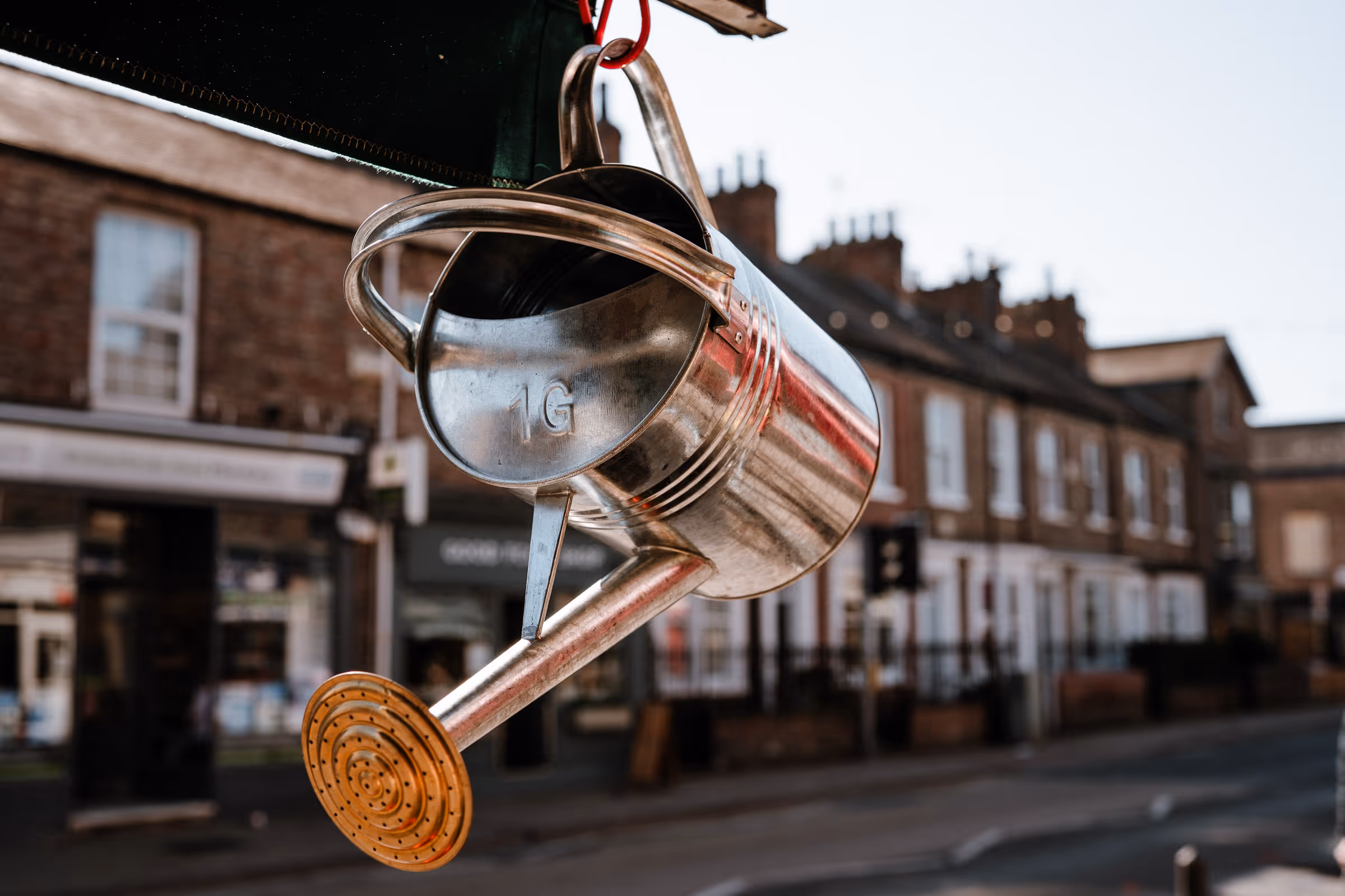 Pextons, shiney watering can hanging on Bishopthorpe Road