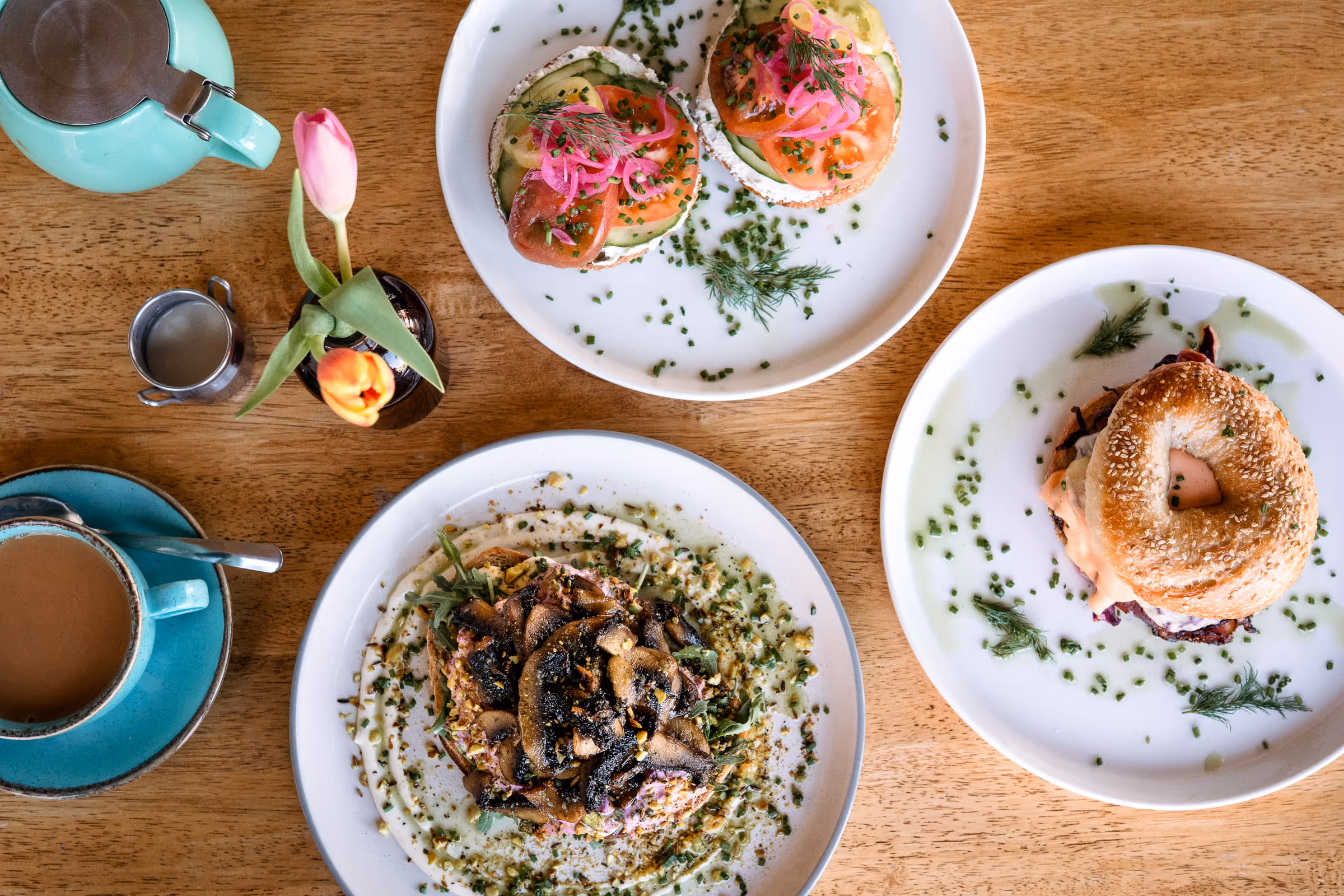 Beautiful top down photo of amazing handmade plates of food and coffees made in Angle on the Green by Bobbin Bagels and the Angel Kitchen.