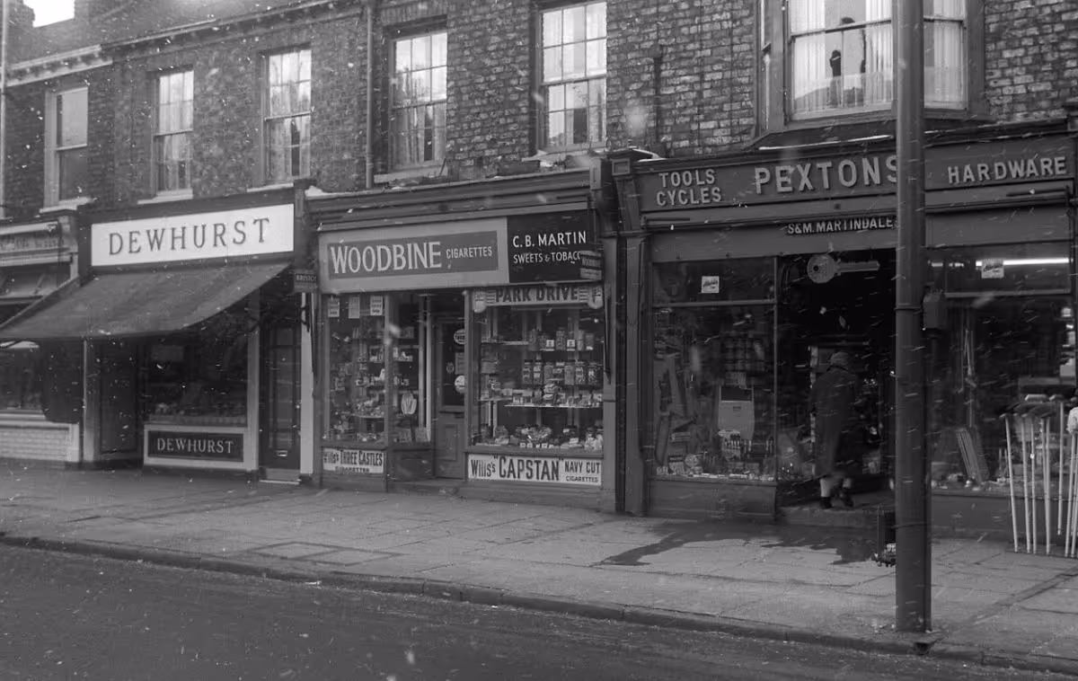Photo of Bishopthorpe Road shop fronts from 1900s with Pextons hardware store