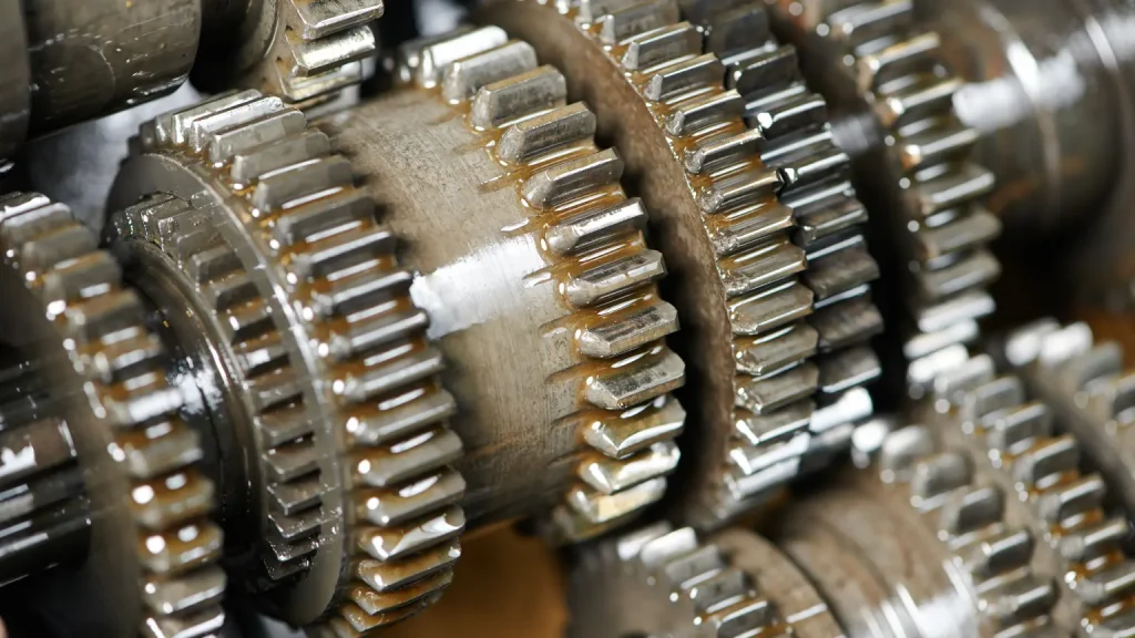 Transmission services for car showcasing a detailed close-up of interlocking, lubricated transmission gears