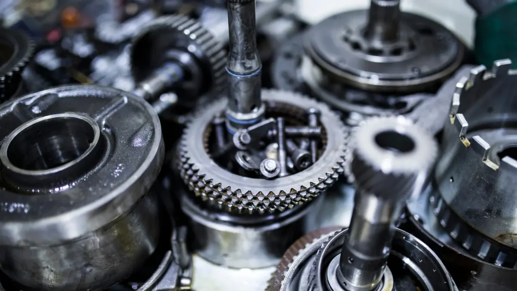 Close-up of various transmission gears and components arranged on a surface