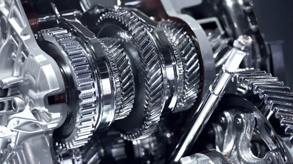 Car transmission repair showing shiny, interlocking gears of a car transmission system under maintenance