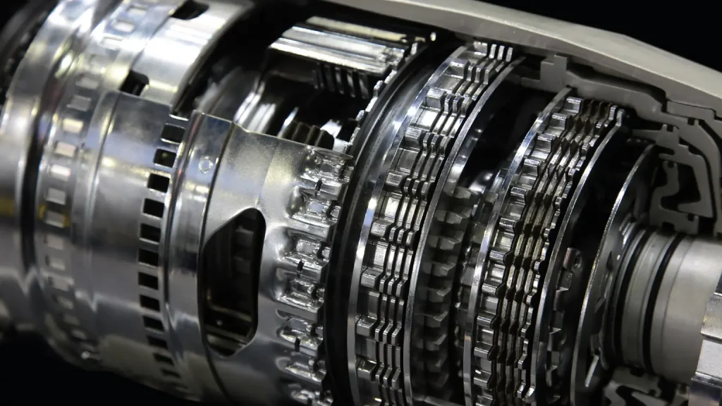 Automotive transmission repair focuses on the intricate internal components of a gearbox, showcasing metal gears and clutch plates