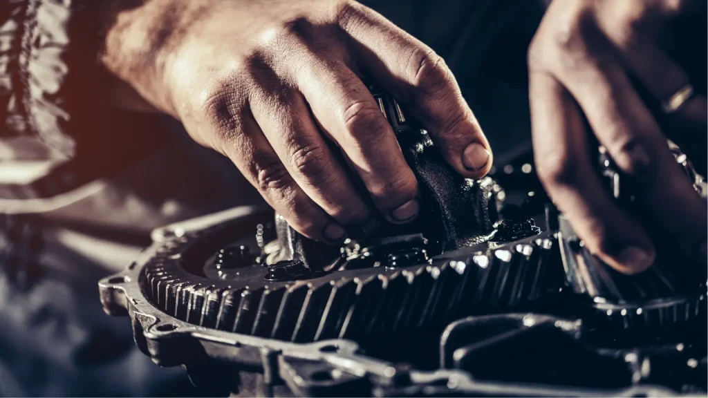Mechanic working on intricate transmission gears for repair or maintenance