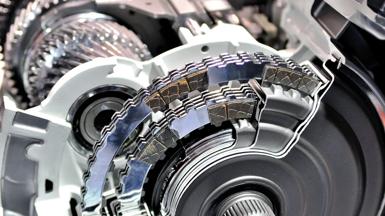 Radiator transmission cooler failure illustrated by close-up of damaged clutch plates and gear mechanisms inside transmission.