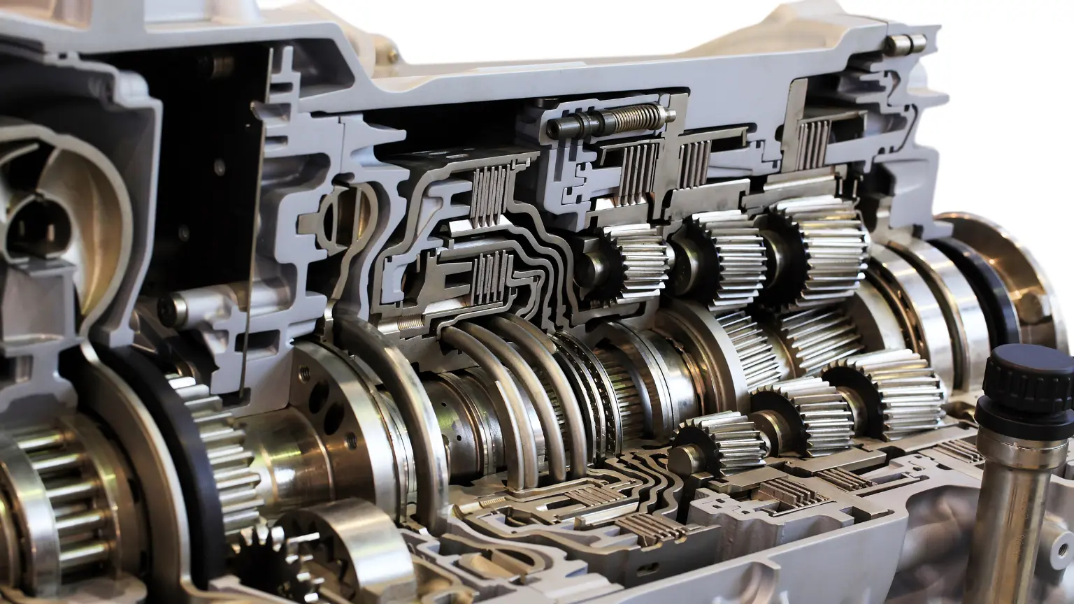 Automated manual transmission cutaway view displaying intricate internal gear mechanisms and hydraulic pathways.