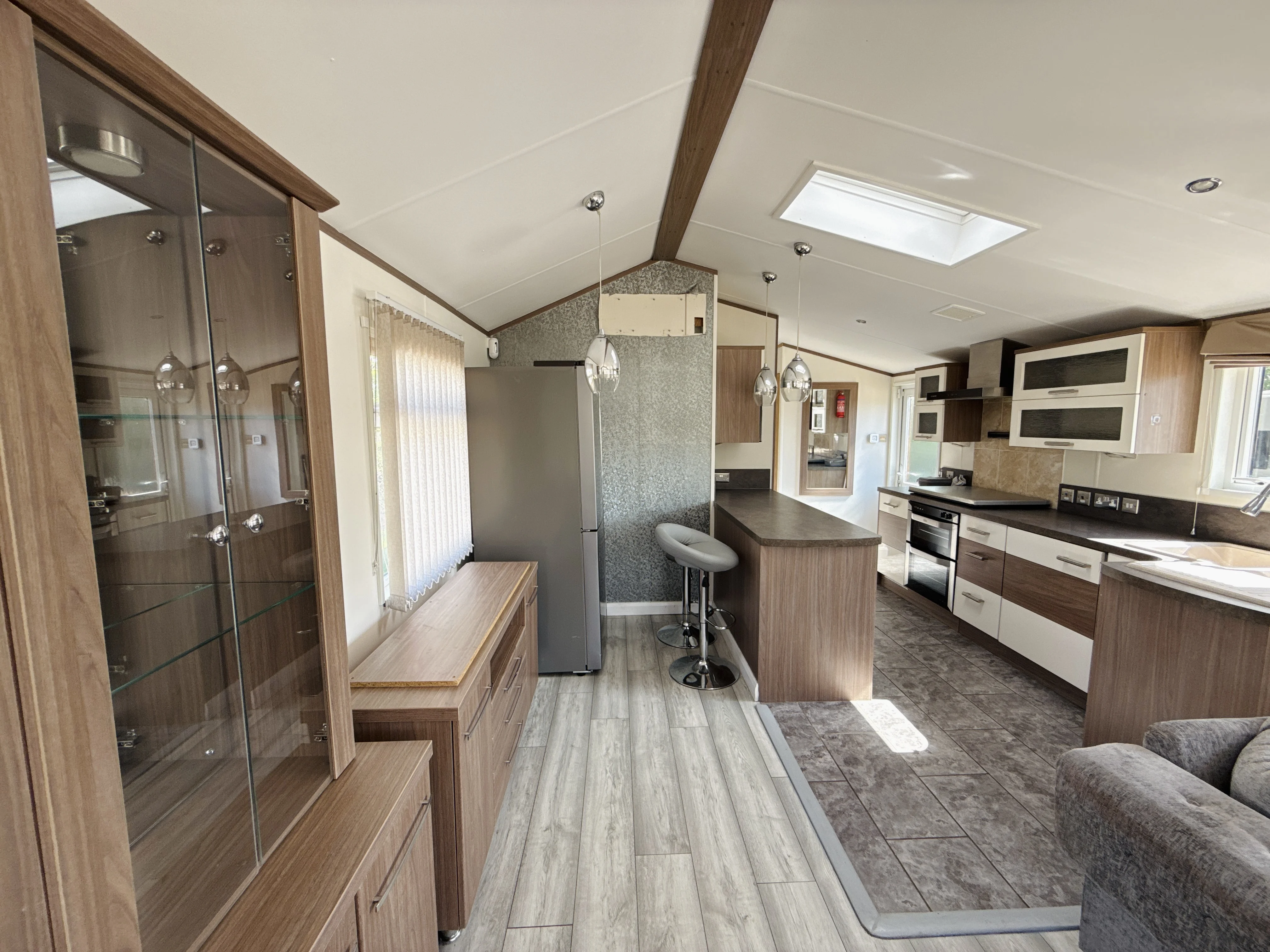 Modern and spacious interior of a mobile home or RV with kitchen