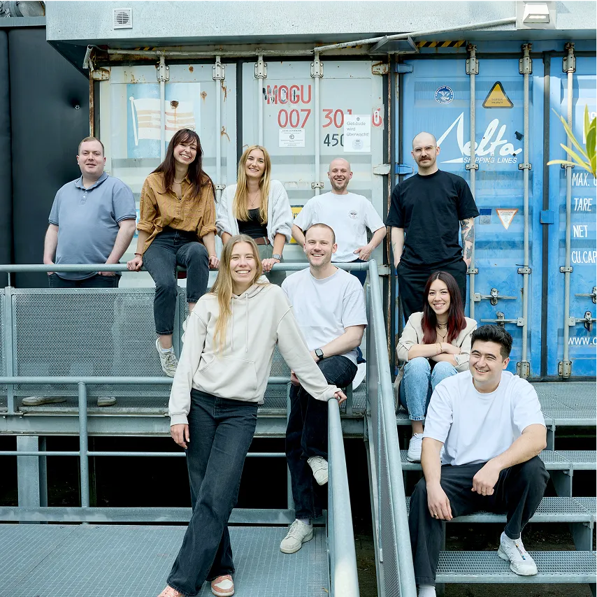 apoio team group picture in front of cargo containers