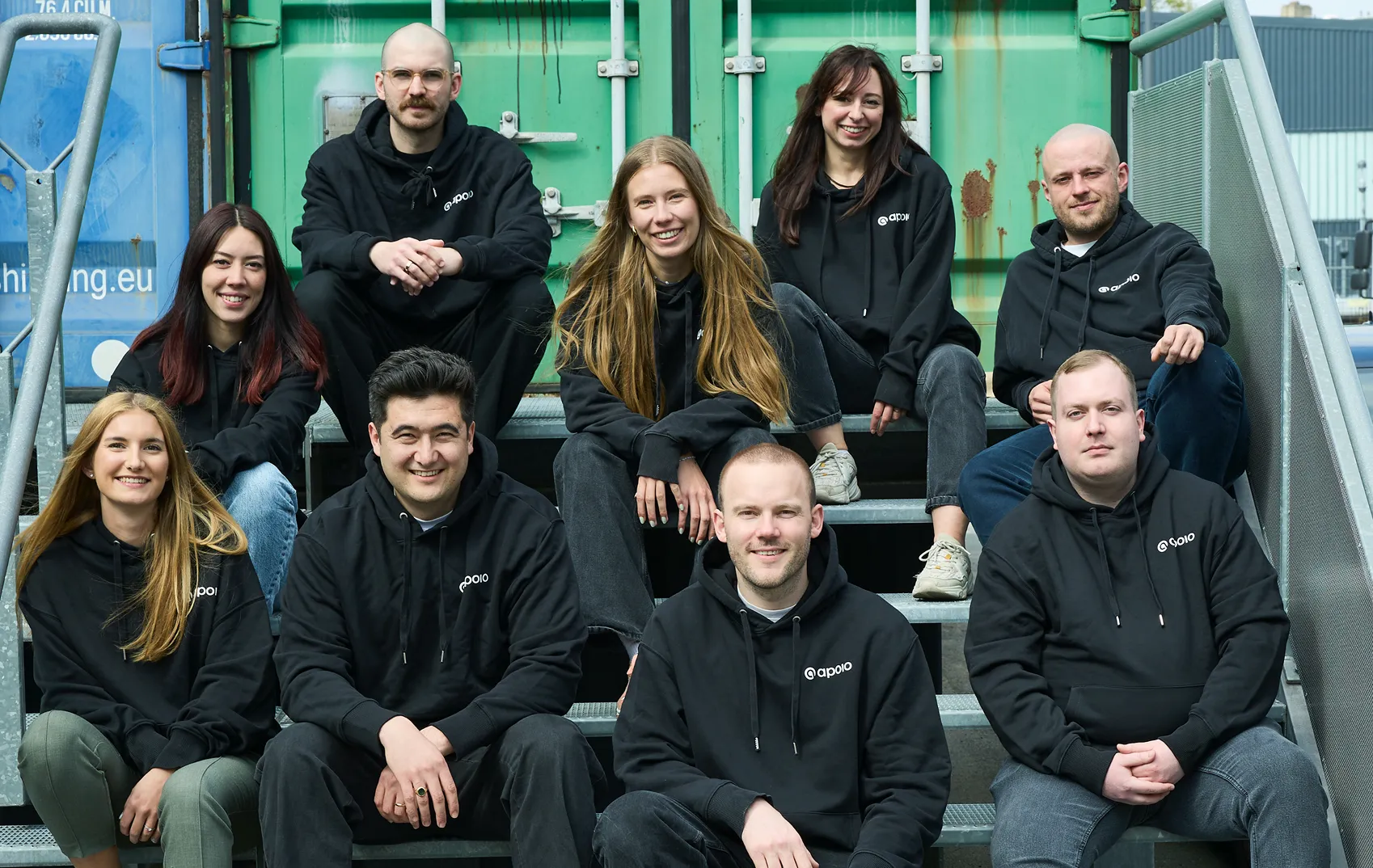 apoio team group picture in front of cargo containers