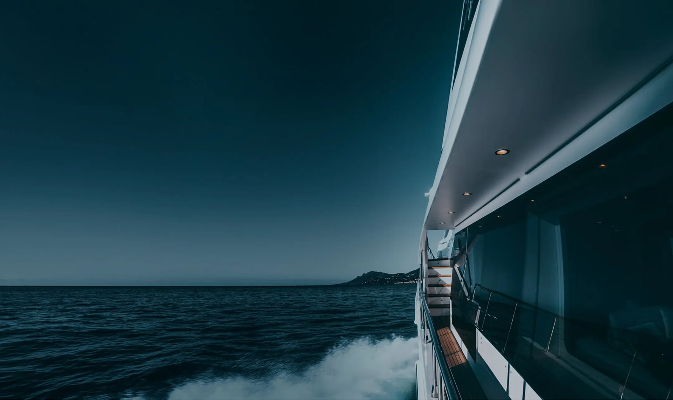 The view from a yacht at night on the sea.