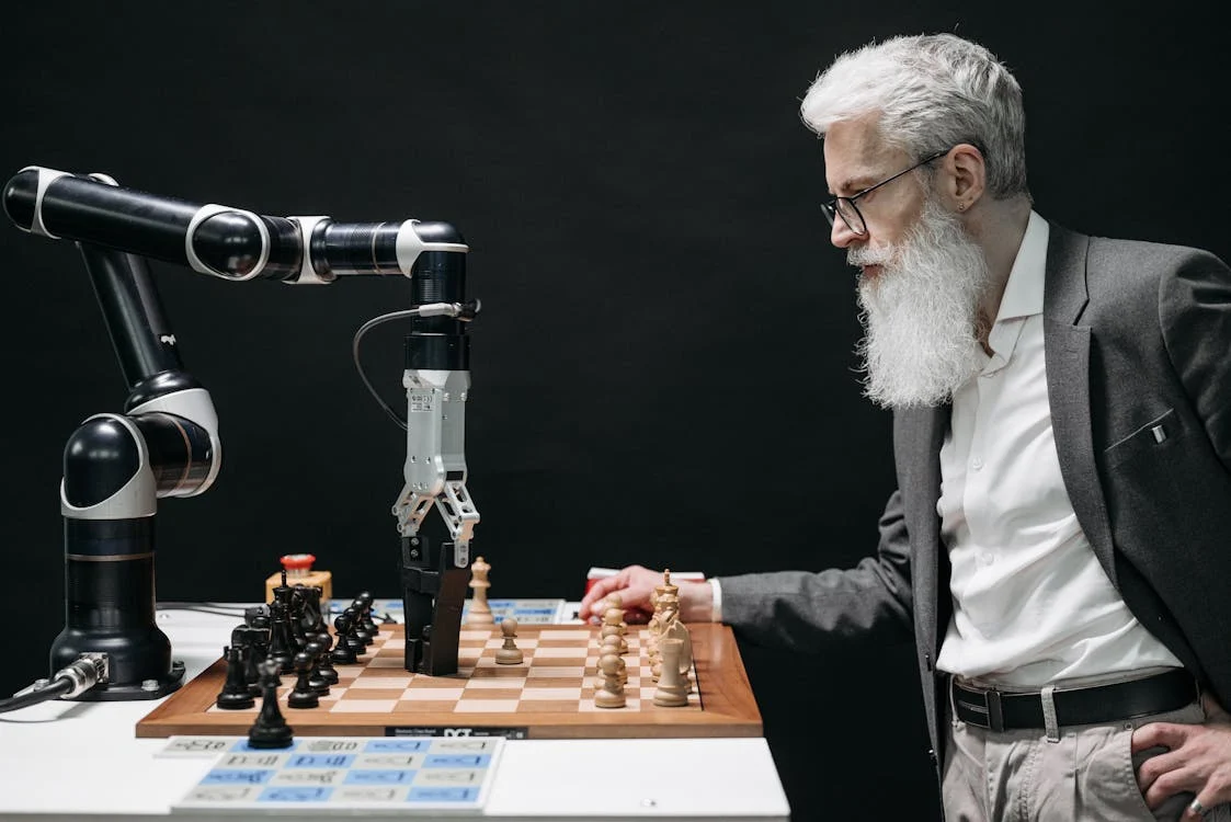 a man playing chess with a robot