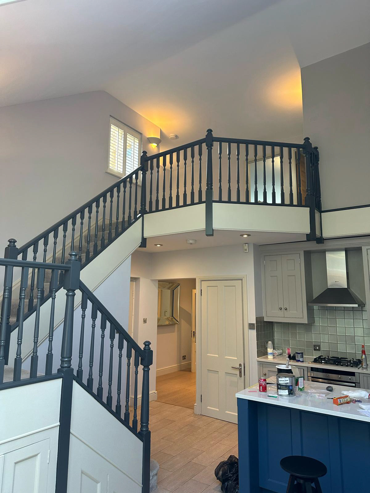 Staircase and kitchen that has been recently decorated.
