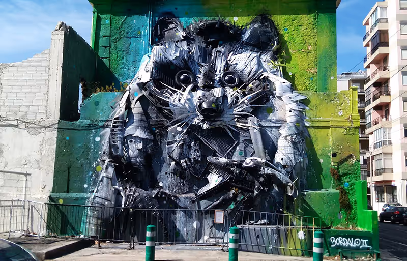 The most creative Lisbon... round and round. If you prefer murals to museums, this tour is for you. Explore the neighborhoods where urban art has transformed facades into open-air galleries. Get to know the works of street art greats such as Vhils, Bordallo II, Obey and many more, all on board a silent 100% electric Tuk Tuk, which takes you in style and without polluting the vibrant and expressive scenery. Artists on the route: Vhils → Bordalo II → Oze Arv → Obey → Pichiavo → Add/Fuel → Tamara Alves → Kruella d'Enfer 