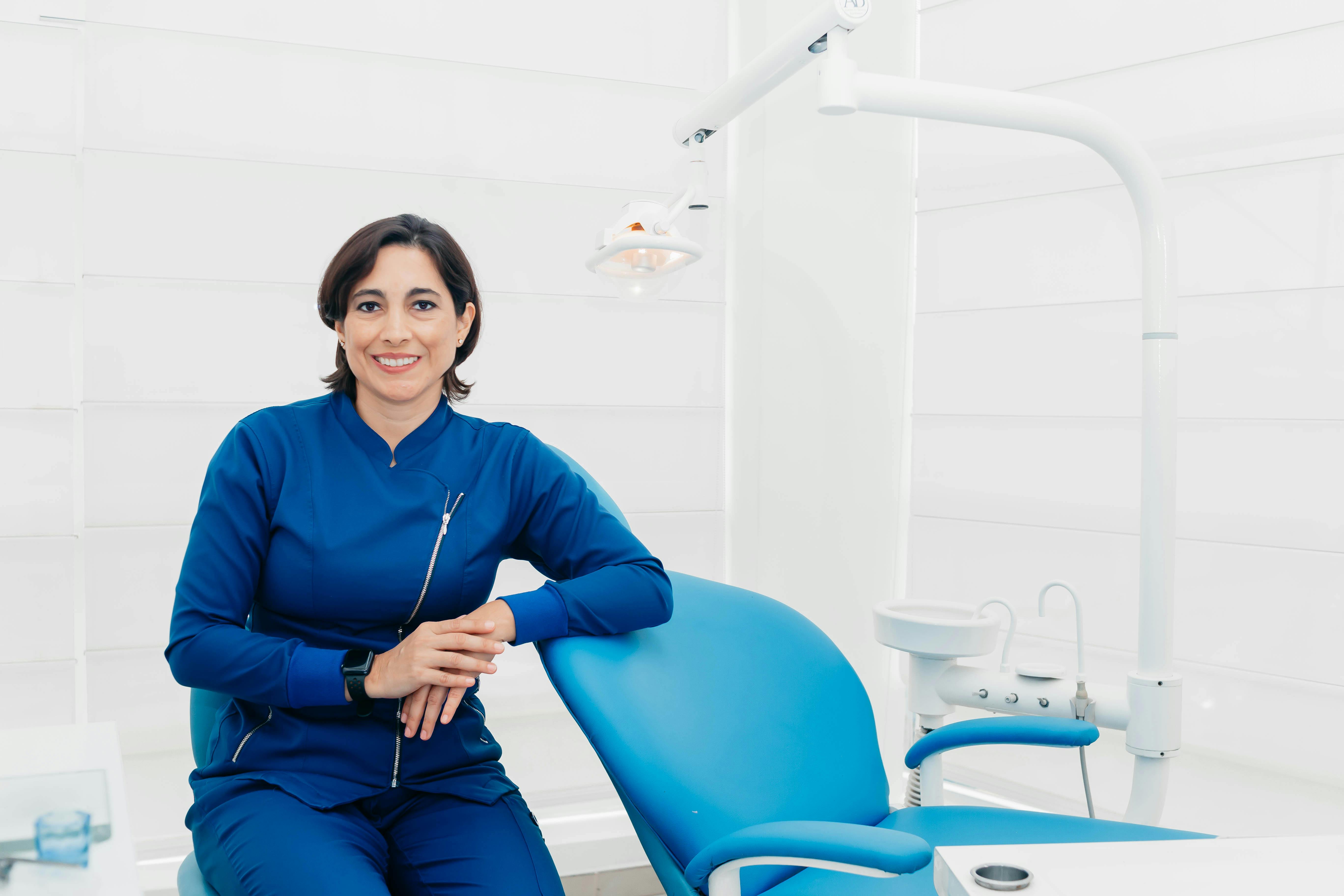 Dentist leaning against a dental chair