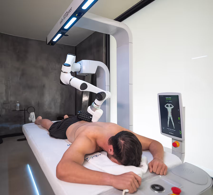 man laying on the roboSculptor massage table