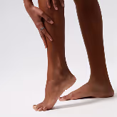 A close up of a person's legs with a ring on it.