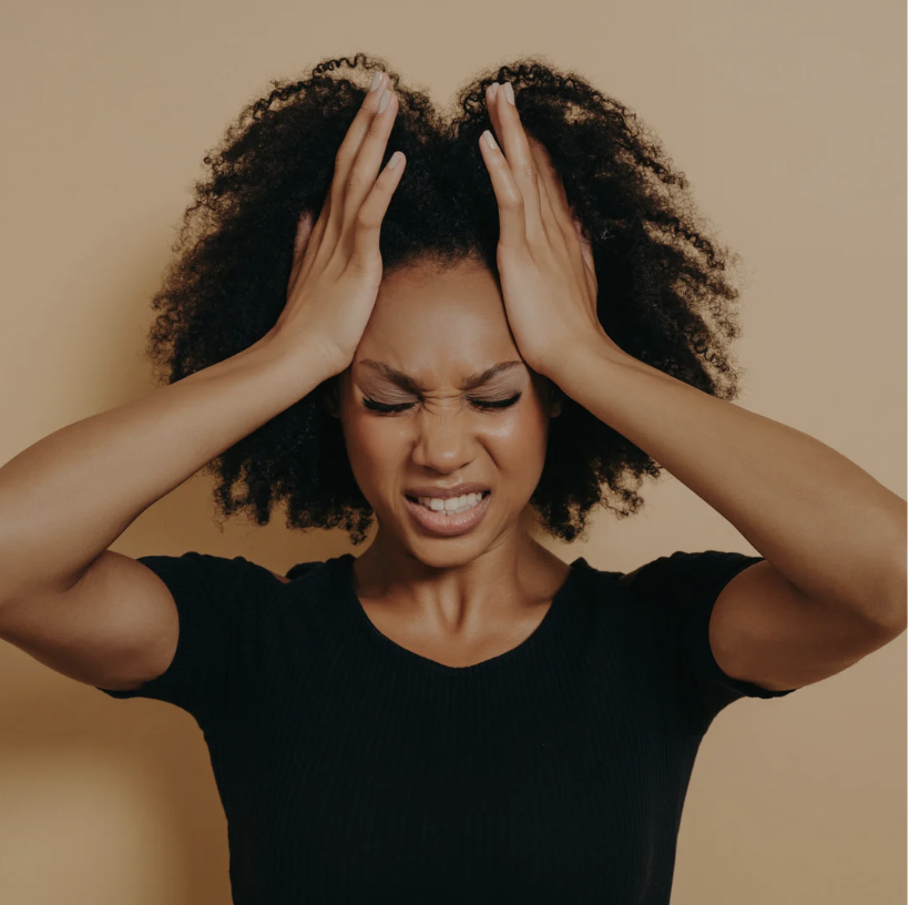 frustrated black woman clutching head