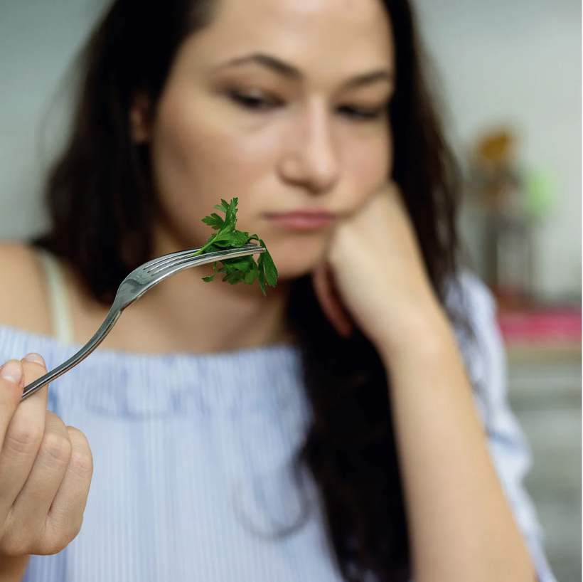woman sad eating salad