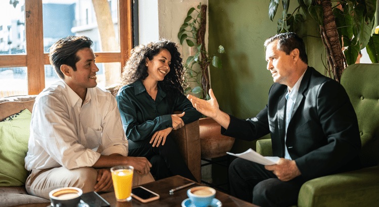 Tampa Bay home sellers reviewing an inspection report with their real estate agent at the kitchen table