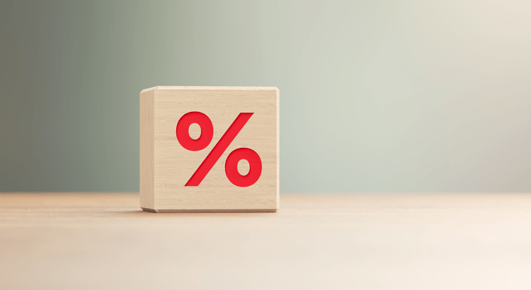 Wooden block displaying a red percentage symbol.