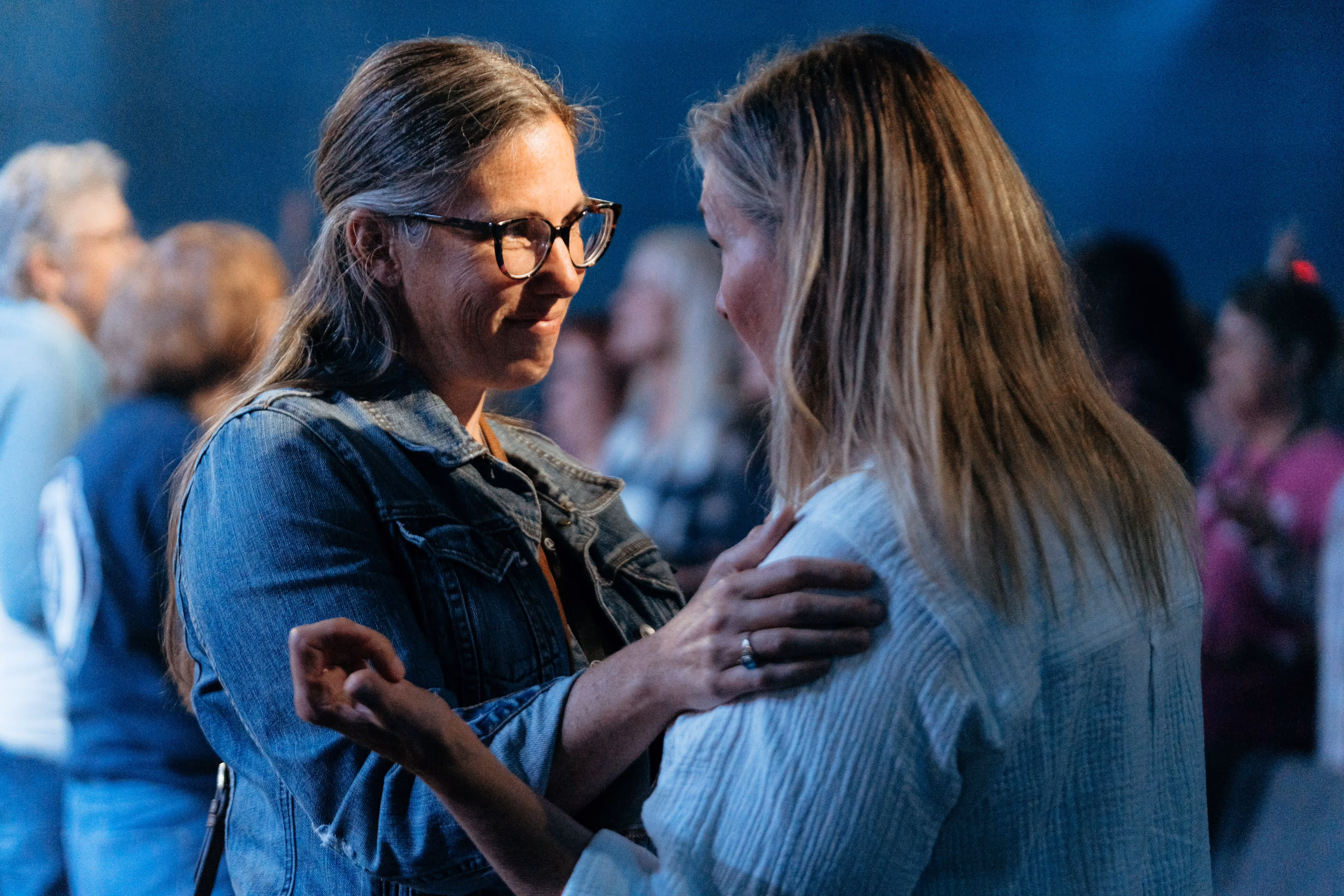 apc hampton campus 2 women looking at each other and smiling before praying