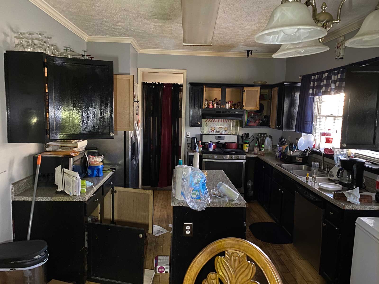 BEFORE Pic of inside of kitchen that had flood damage. Showing the state of a home before NDRMI gets involved