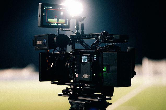 A cinema camera rig with a monitor set up on a night exterior
