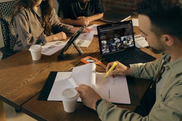 Three filmmakers around a table with Frame Set open on a tablet