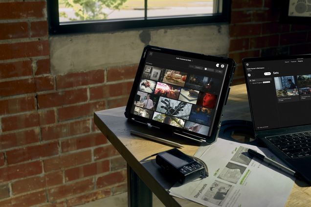 A tablet showing a Set of Frames on a bench beside printed pages