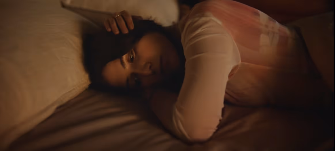 A low-key lit still from Lila Drew's music video Lila's Theme.