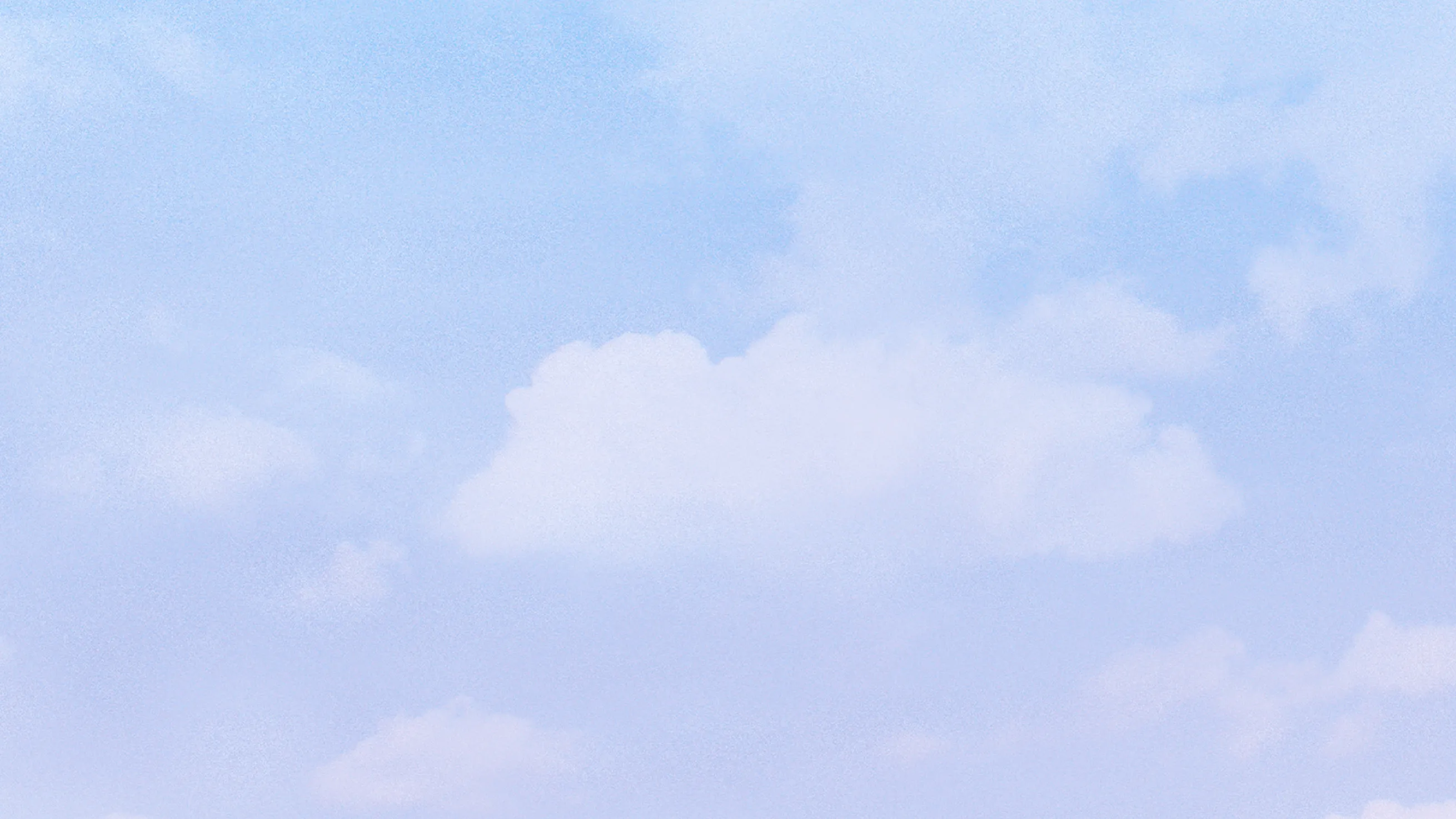 Soft blue sky with fluffy white clouds scattered throughout.
