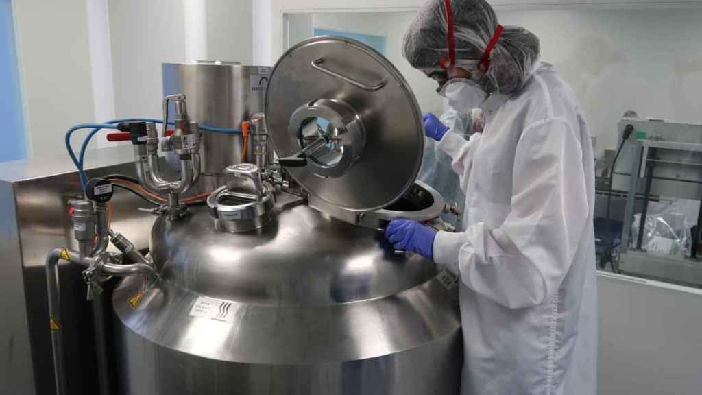 Technician working with pharmaceutical production equipment