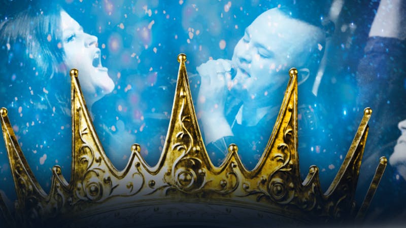 A golden crown in front of a man and a woman singing with a blue coloured light on them