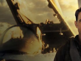 Photo of Tom Cruise in front of an aircraft