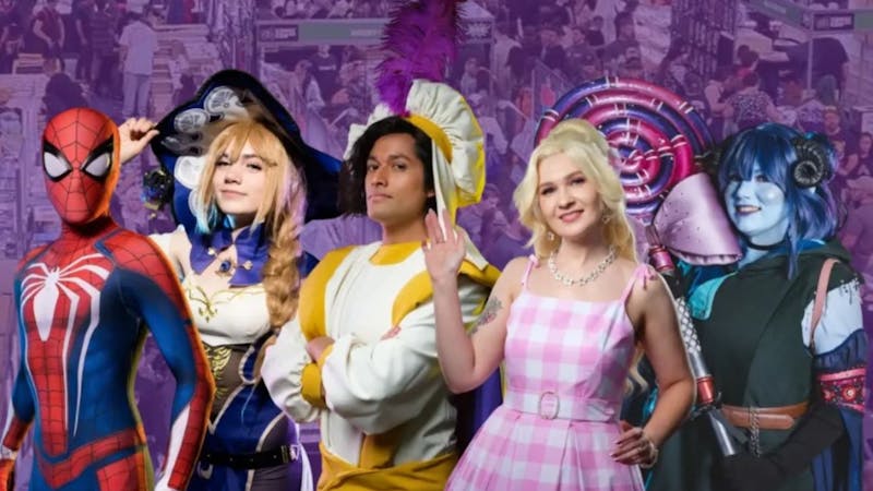 Photo of 5 cosplayers in their costumes behind a purple background of the exhibition hall