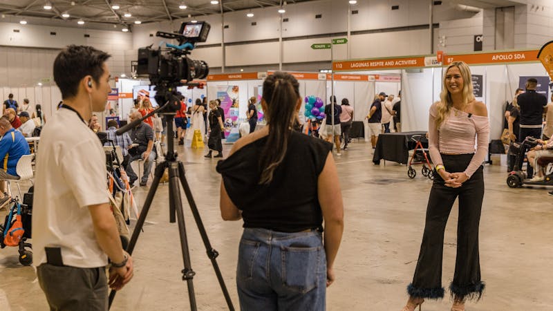 Two staff members interviewing Ambassador Anja Christoffersen at Brisbane 2024