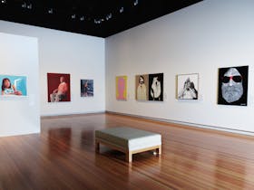 A picture of the gallery with images of some of the finalists artworks