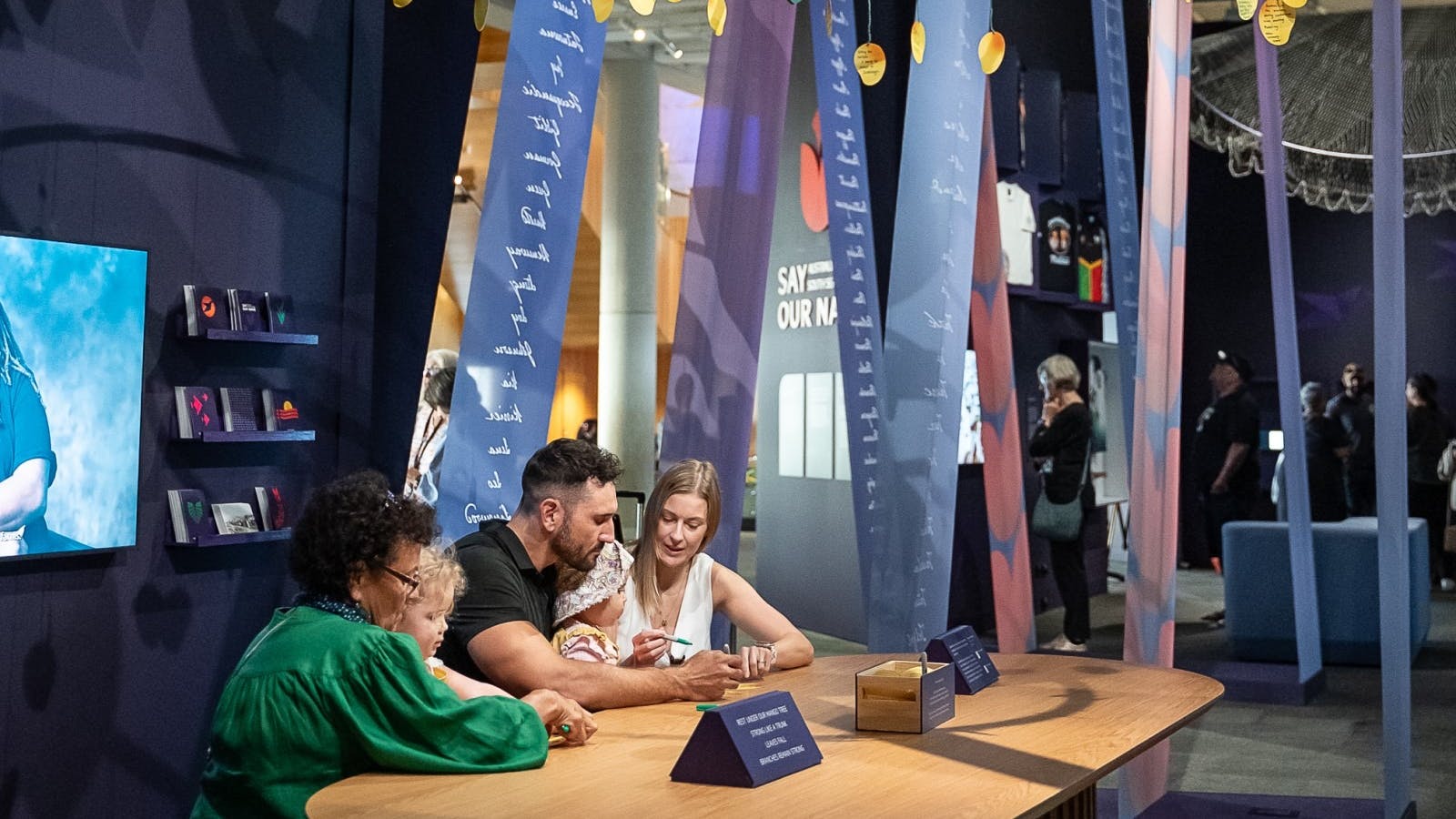 Guests sitting at a table inside exhibition space