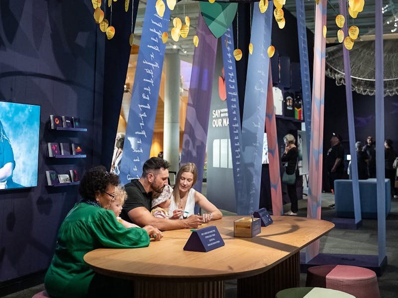 Guests sitting at a table inside exhibition space